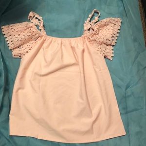 Soft pink blouse with crochet sleeves